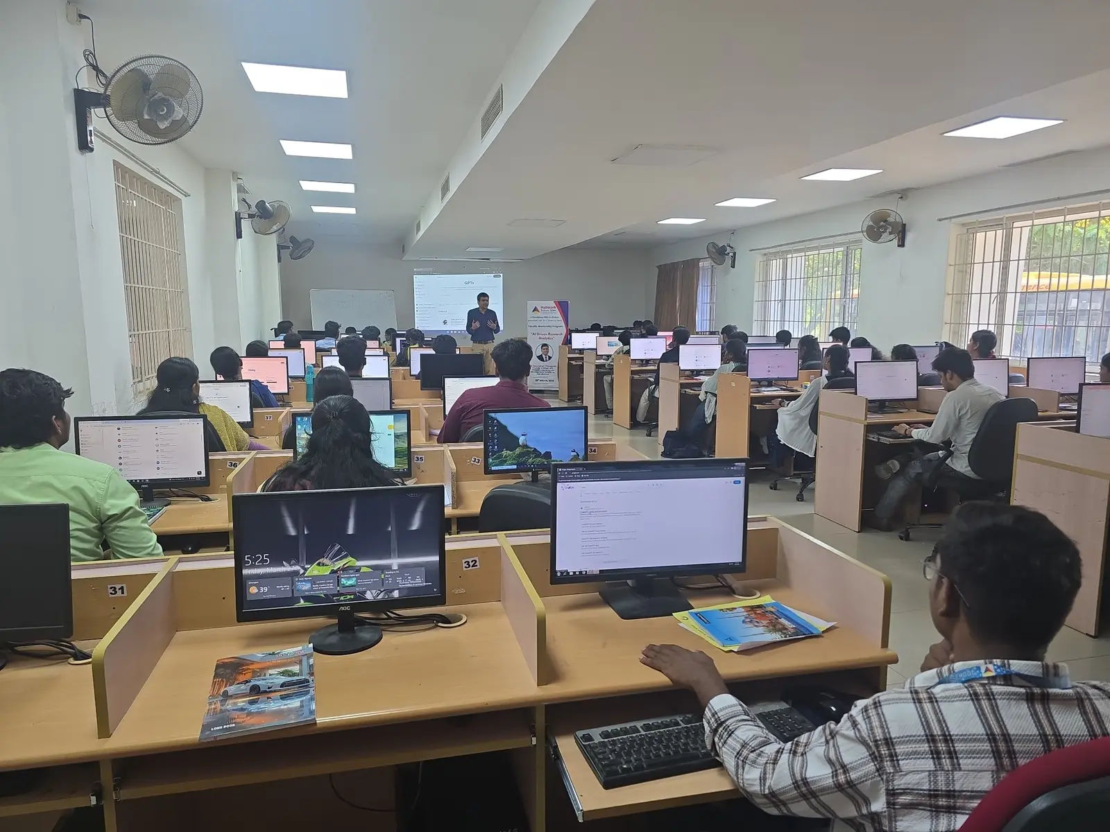 Participants practising with generative AI tools during a computer-lab workshop