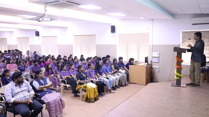 Facilitator addressing participants in an auditorium