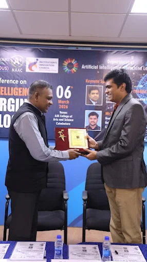 A professional receiving recognition on a conference stage